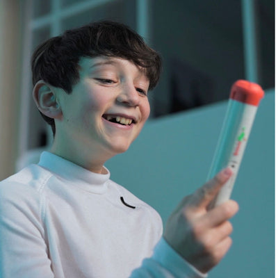 Kid playing with the Stickflip electronic skill game